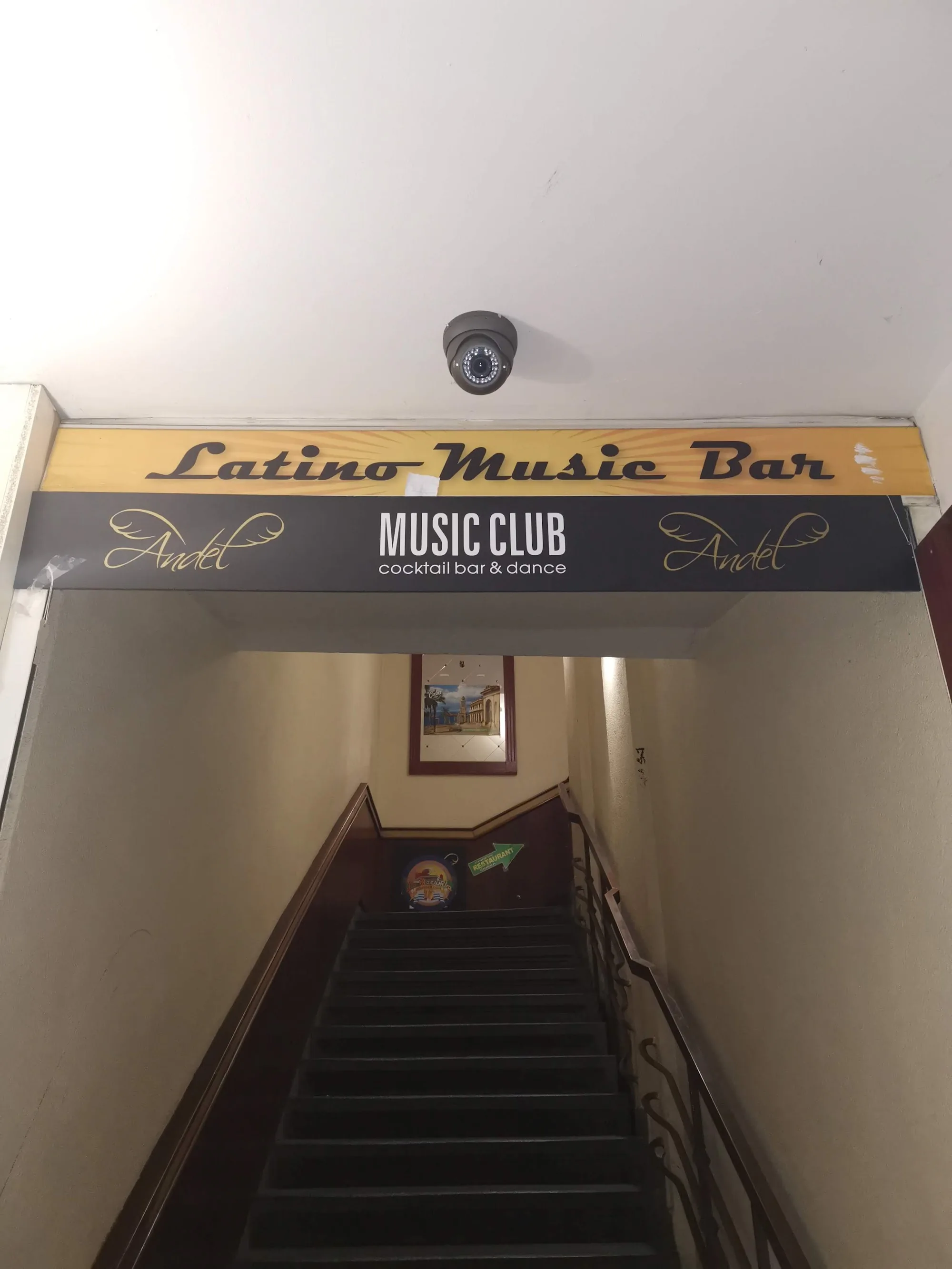 Entrance sign reading Latino Music Bar and cocktail bar & dance club at La Macumba