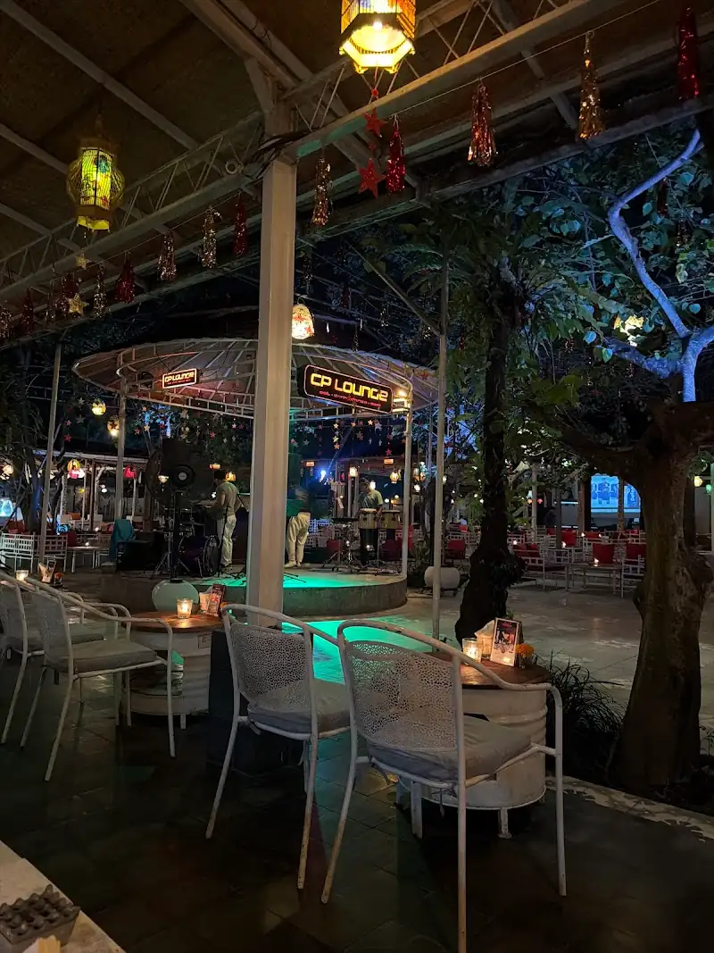 CP Lounge Bali outdoor stage and dance floor area with colorful lanterns, Christmas decorations, and atmospheric evening lighting
