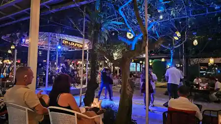 People dancing at CP Lounge Bali outdoor venue with live band on stage and blue stage lighting at night — salsa, bachata venue in Bali