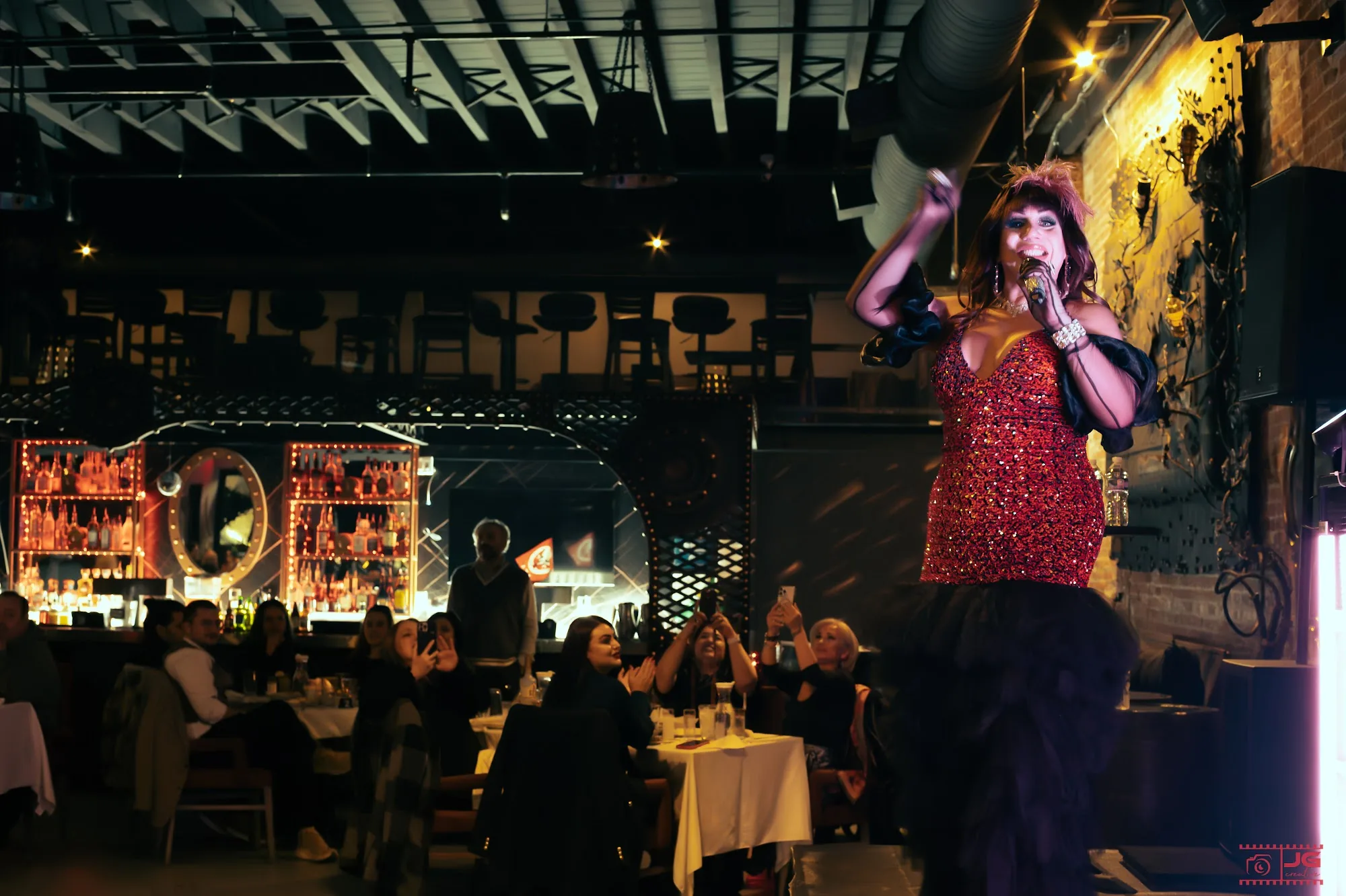 Live performer on stage with audience at Atolye Venue & Bar in New York