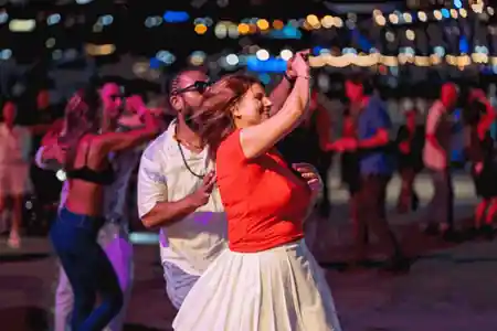 Couple dancing salsa with bokeh lights at Palm Grove Latin Nights, Darling Harbour Sydney