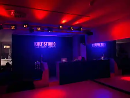 Kult Studio Munich event stage with DJ booth and red and blue club lighting — bachata venue in Munich