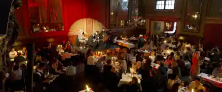 Candlelit evening at Cl\u00e4rchens Ballhaus Berlin with guests and live music in the historic ballroom — salsa venue in Berlin