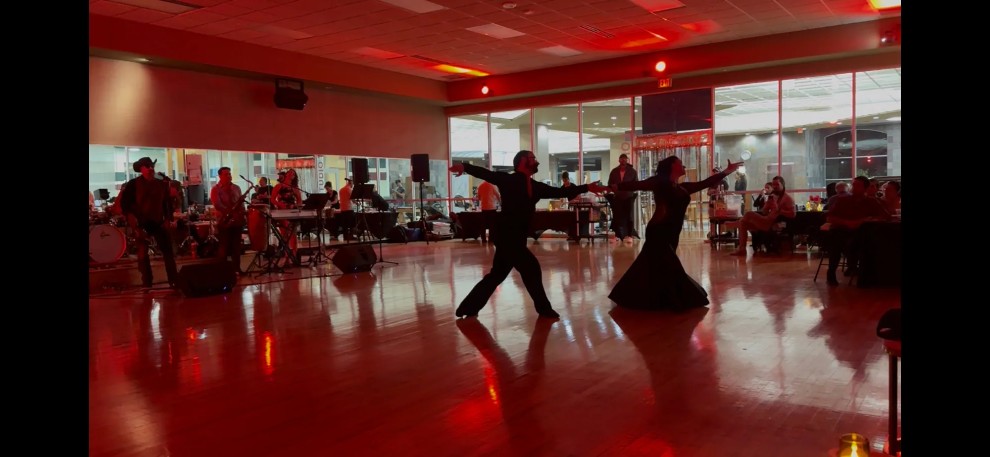 Couple performing with a live band on the dance floor at Blue Moon Dance Co., Austin