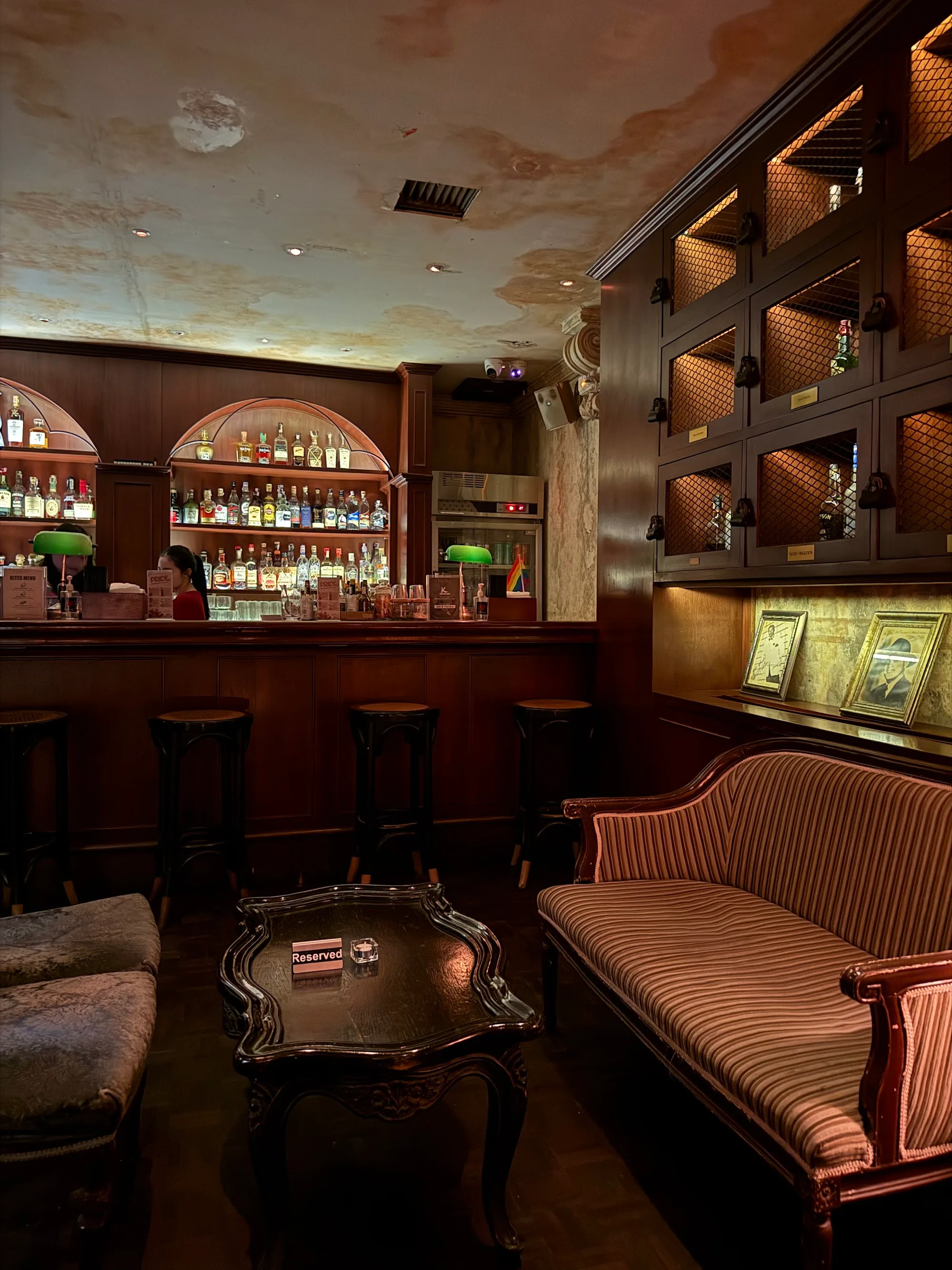 Intimate lounge seating area with dark wood and vintage decor at Havana Social Bangkok