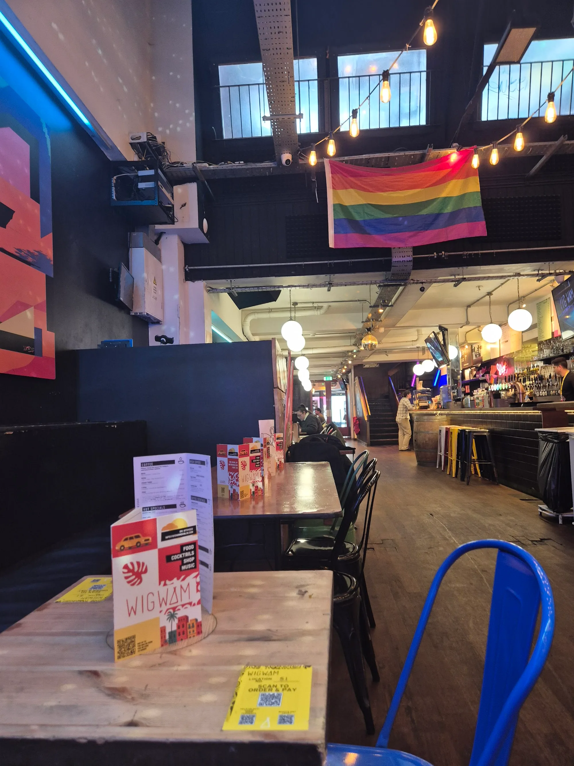 Wigwam Dublin bar interior with rainbow pride flag and neon lighting