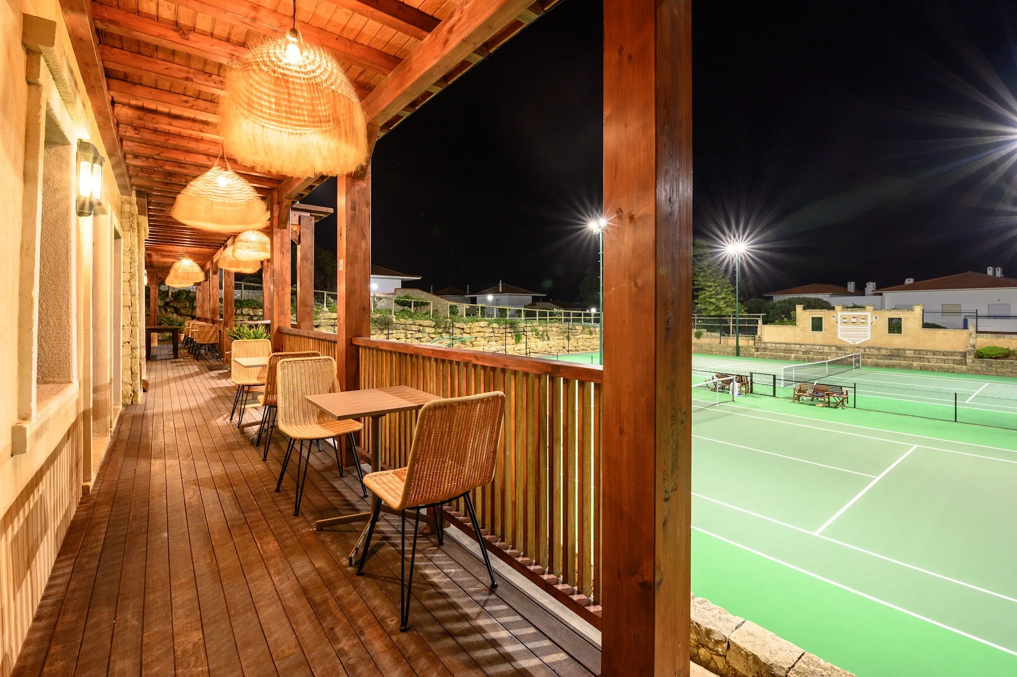 BreakPoint Ericeira terrace with wicker pendant lights overlooking sports court