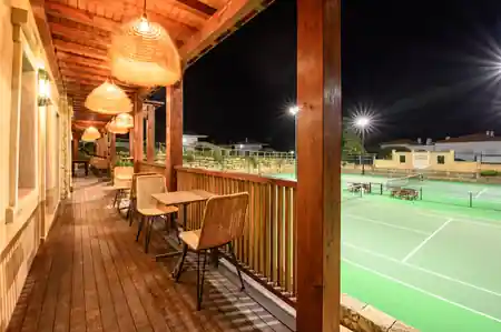 BreakPoint Ericeira terrace with wicker pendant lights overlooking sports court — salsa, bachata, kizomba venue in Ericeira