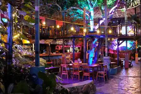 Colorful tropical interior with bar, lounge seating, and string lights at Hatch Bar in Bali — salsa, bachata venue in Bali