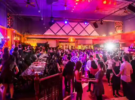 Crowded dance floor with colorful lights and live stage at Lula Lounge Toronto — salsa venue in Toronto