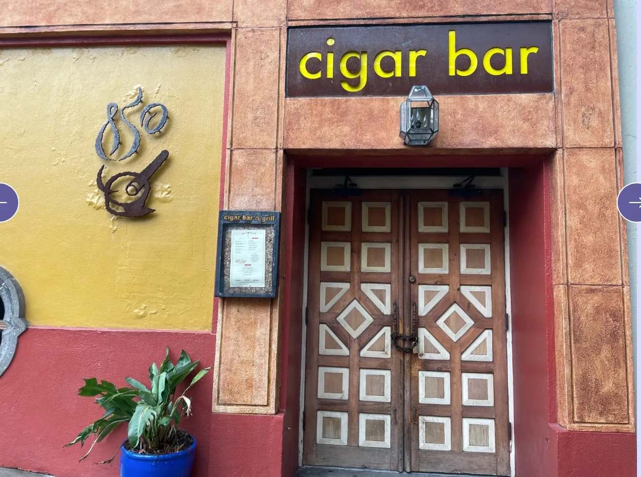 Cigar Bar & Grill exterior entrance with branded yellow signage in San Francisco