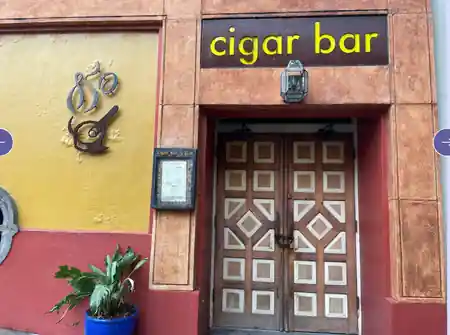 Cigar Bar & Grill exterior entrance with branded yellow signage in San Francisco — salsa, bachata venue in San Francisco