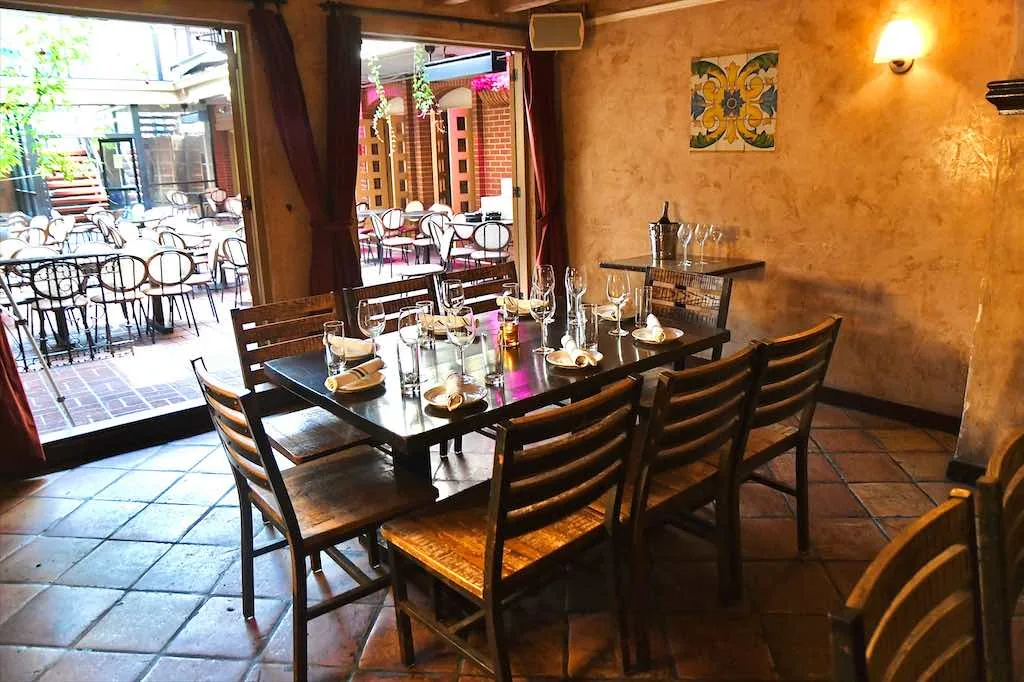 Warm interior of Cigar Bar & Grill San Francisco with patio view and Spanish-tile decor
