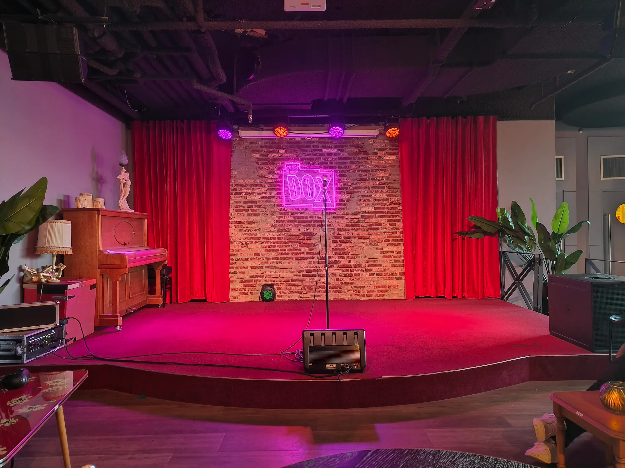 THE DOX neon-lit stage with red curtains at Rotterdam Netherlands salsa venue