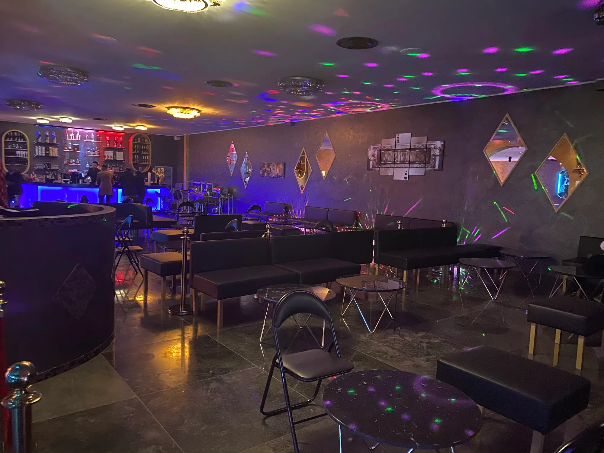 Nightclub interior with lounge seating and disco lights at Time Club Pioltello Italy