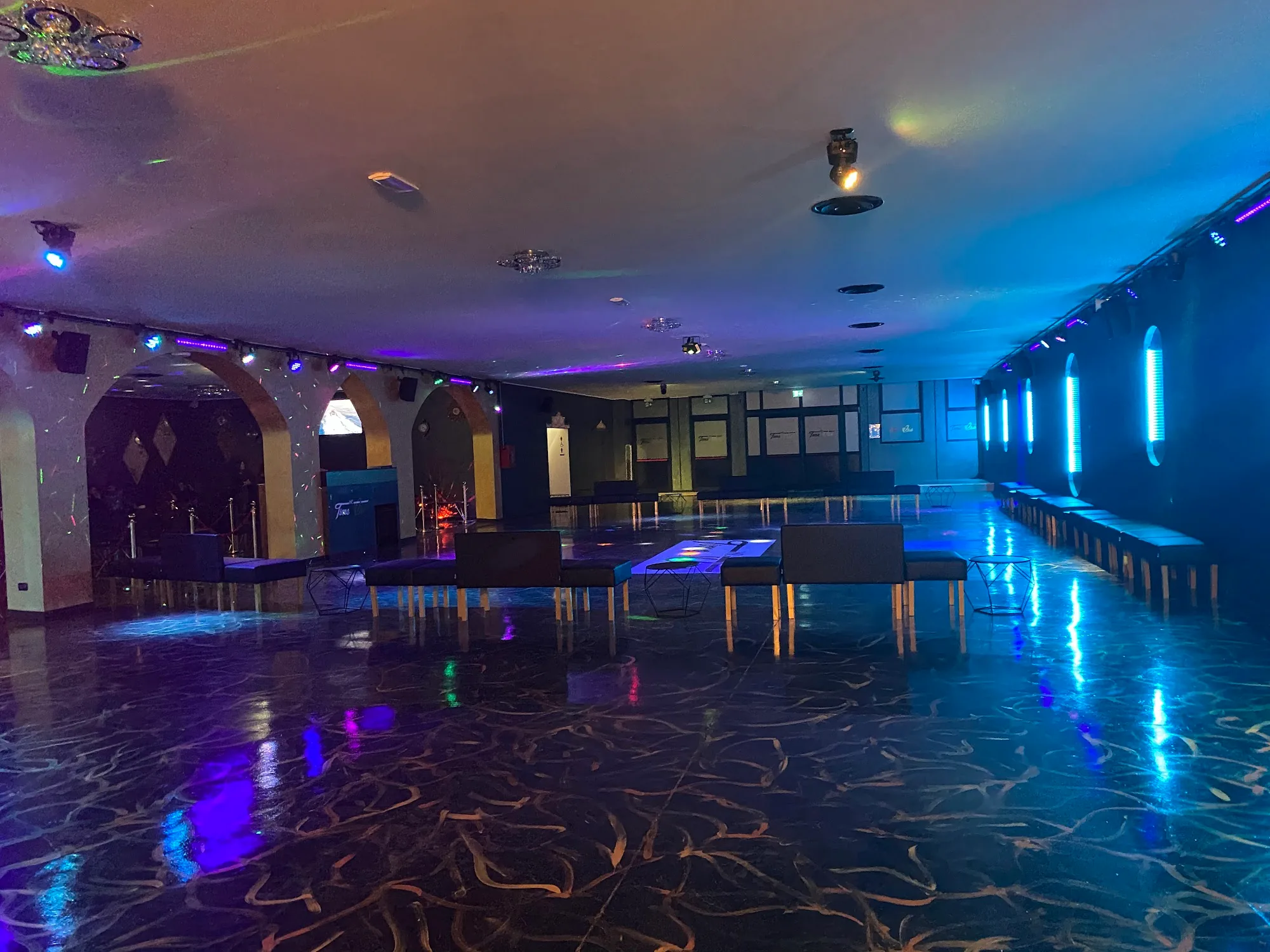 Empty dance floor with blue and purple lighting at Time Club Pioltello nightclub