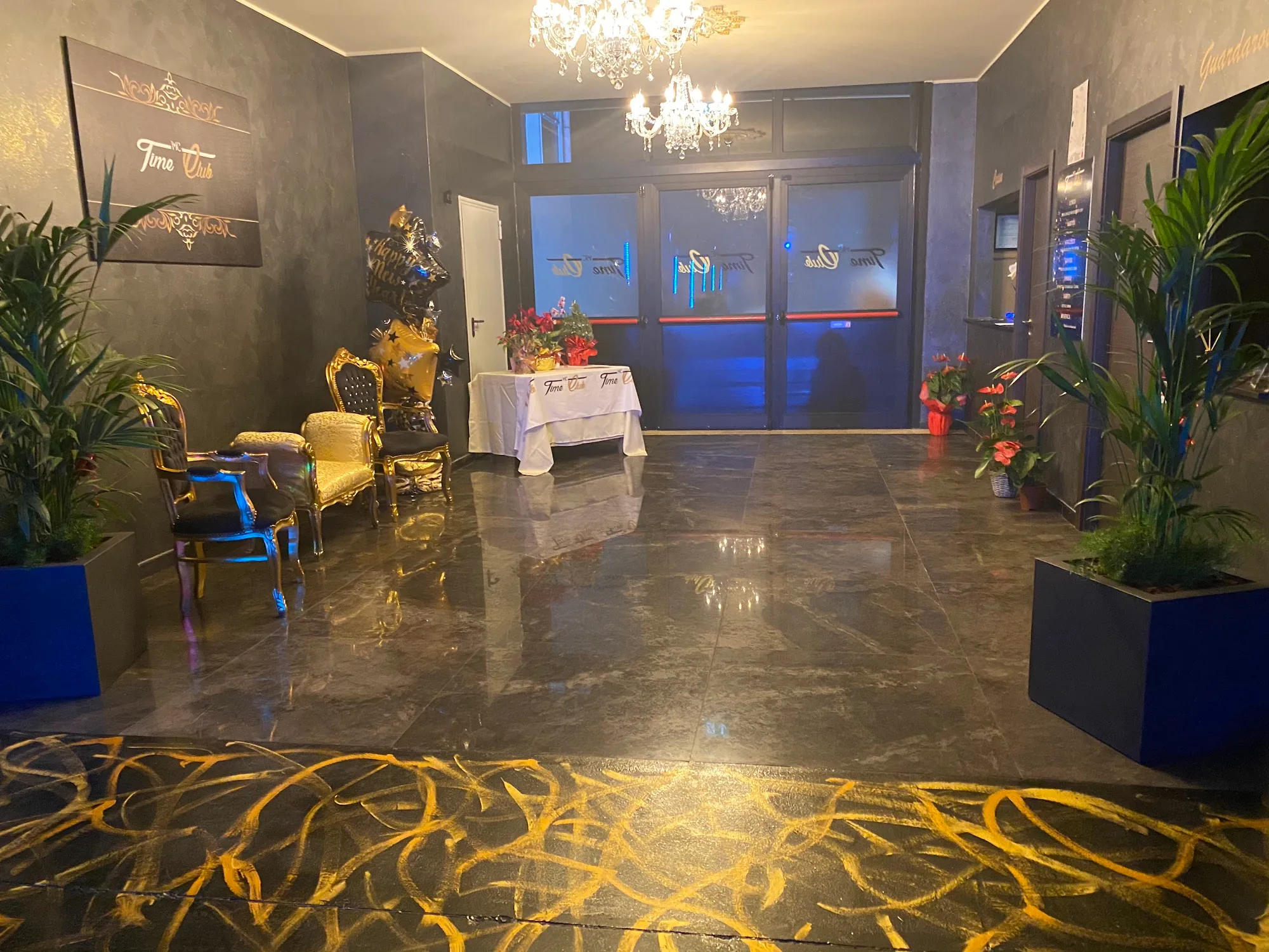 Elegant marble entrance foyer with gold accents at Time Club Pioltello Italy
