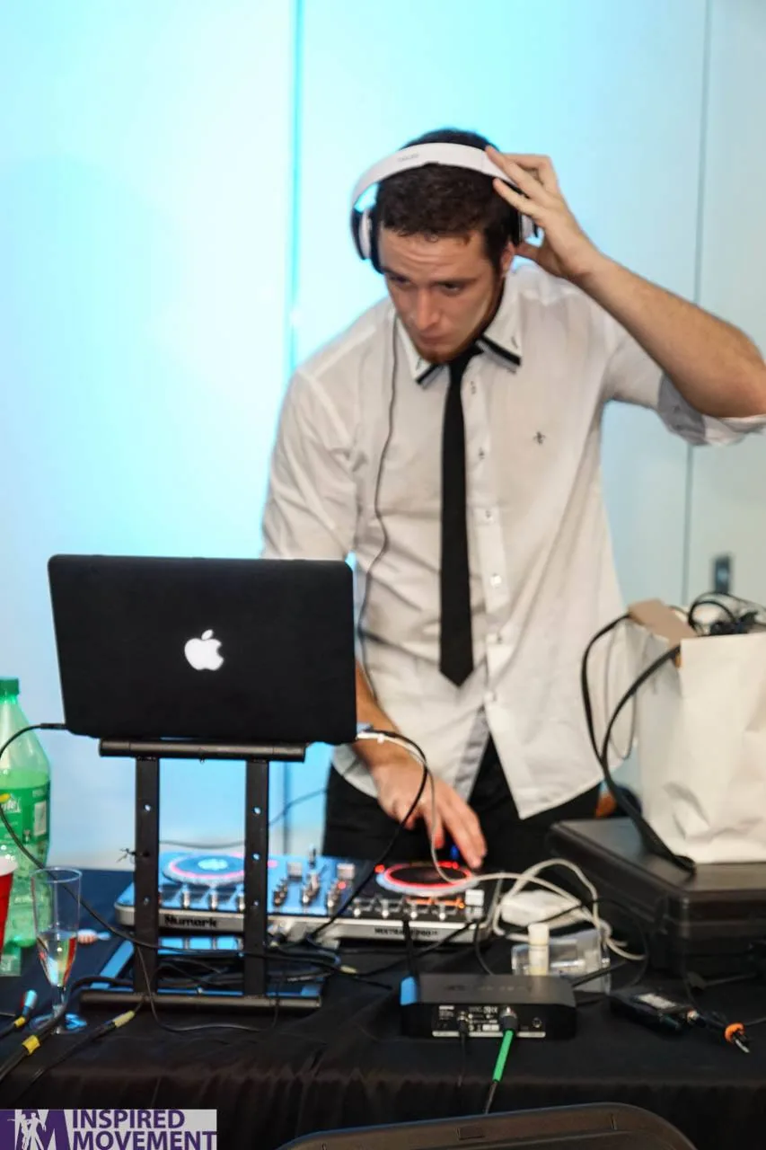 DJ spinning latin music at an Austin Inspired Movement social party in Austin