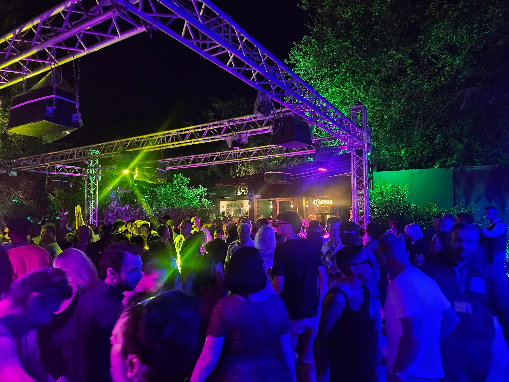 Outdoor party crowd with stage lighting at Ca de Mandorli venue San Lazzaro di Savena