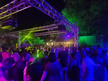 Outdoor party crowd with stage lighting at Ca de Mandorli venue San Lazzaro di Savena — salsa, bachata venue in San Lazzaro di Savena