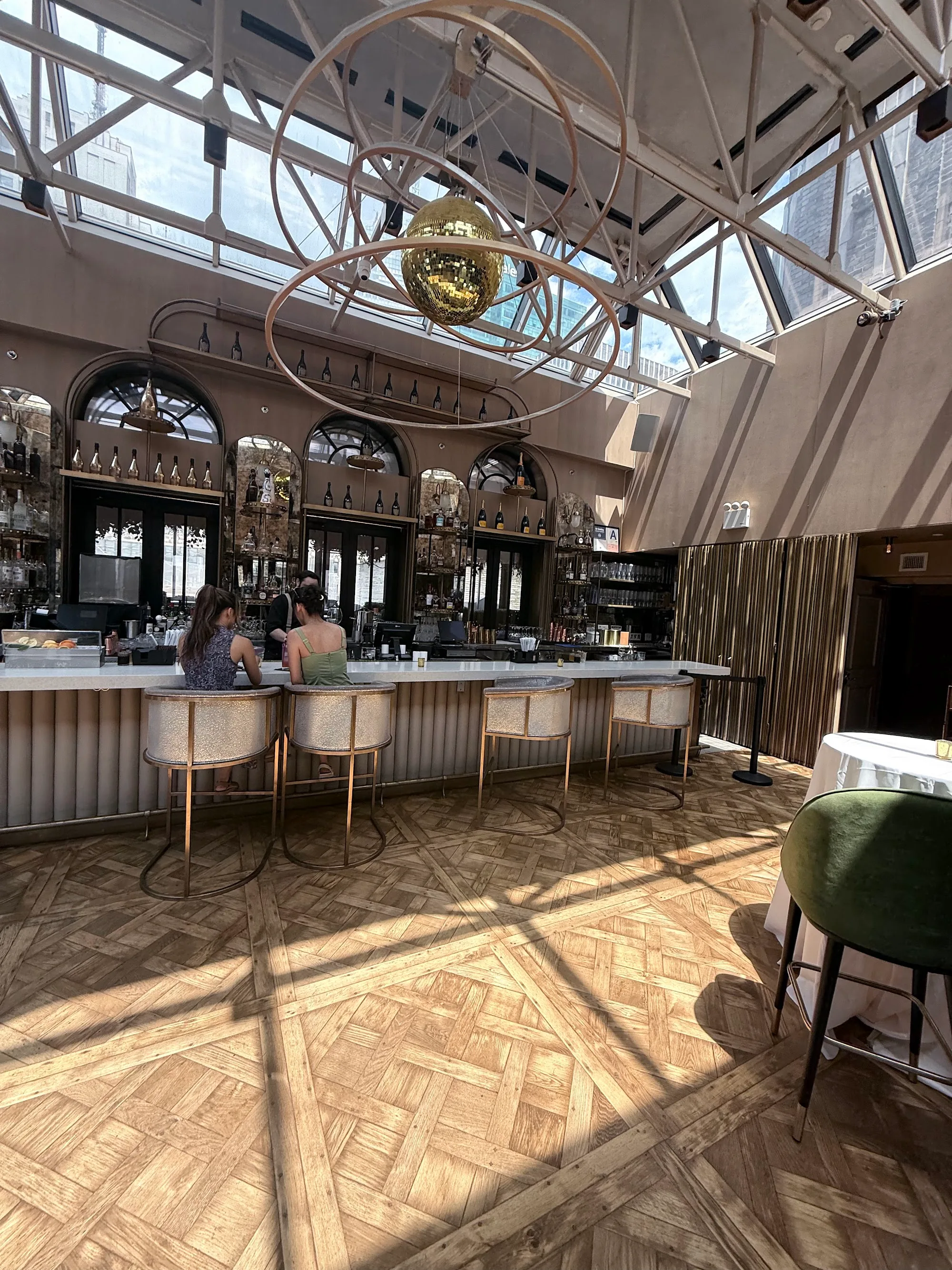 Elsie Rooftop bar and lounge in New York with skylights, disco ball and patrons