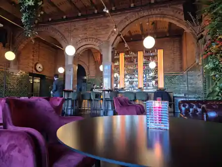 Grand arched brick interior and bar at The Brokers Bar in Amsterdam — salsa venue in Amsterdam