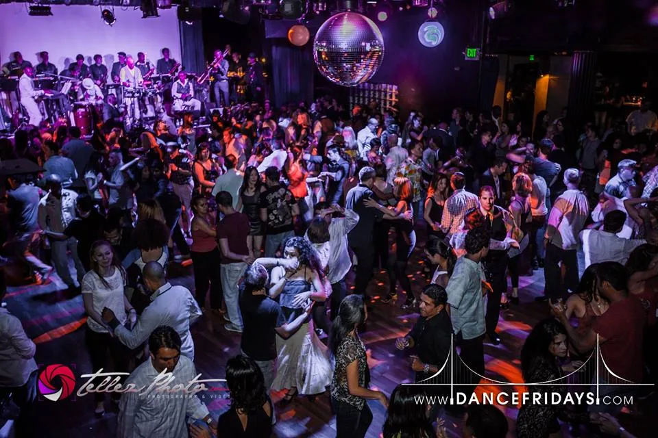 Crowded salsa social with live band and disco ball at Dance Fridays, San Francisco