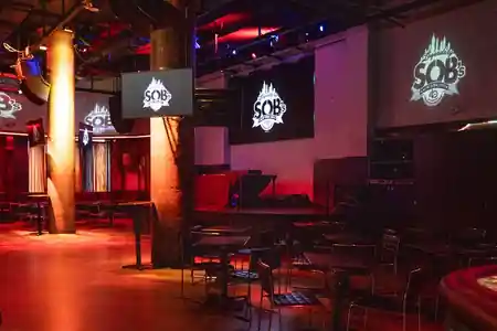 Sound of Brazil NYC stage area with SOB's branded screens and warm club lighting — salsa venue in New York
