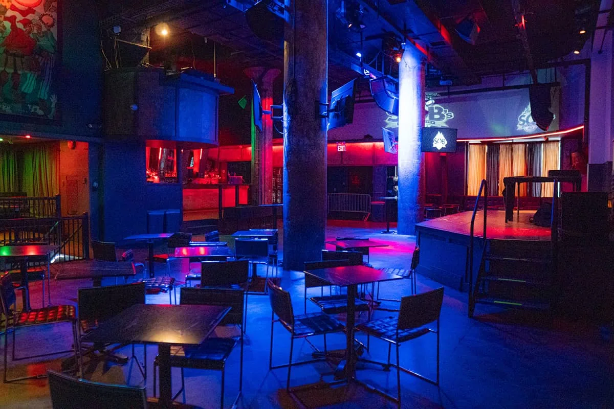SOBs (Sound of Brazil) venue interior in New York showing the stage, dance floor, and atmospheric blue and red lighting — salsa venue in New York