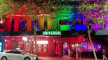 Universal Sydney venue exterior at night with rainbow lighting and signage in Oxford Street — salsa, bachata venue in Sydney