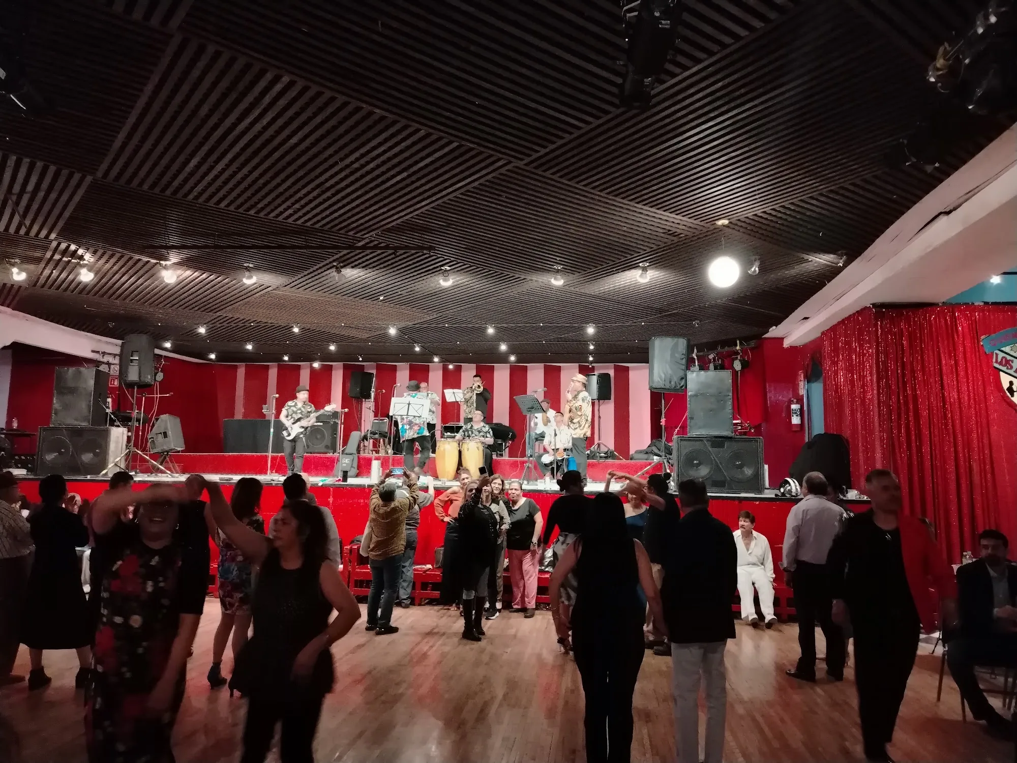 Live salsa band on stage with dancers and crowd at Salón Los Ángeles Mexico City