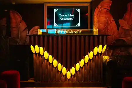 Art deco DJ booth with DECODANCE signage at DecoDance Bar in San Francisco — salsa, bachata venue in San Francisco