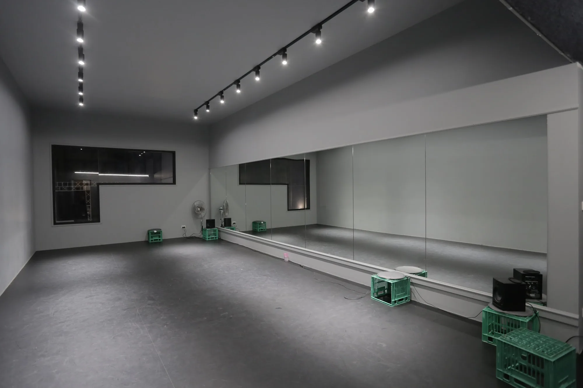 Spacious dance studio interior with mirrored wall and track lighting at Dance IM in Melbourne