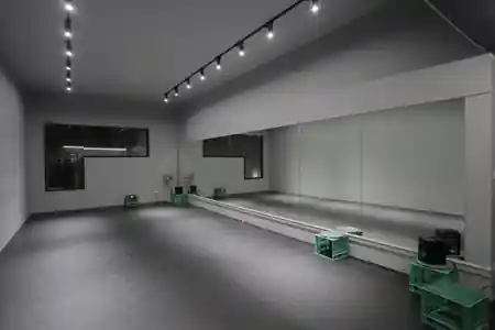 Spacious dance studio interior with mirrored wall and track lighting at Dance IM in Melbourne — zouk venue in Melbourne