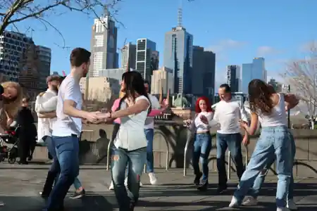 Dance IM social dancing outdoors with Melbourne city skyline in the background — zouk venue in Melbourne