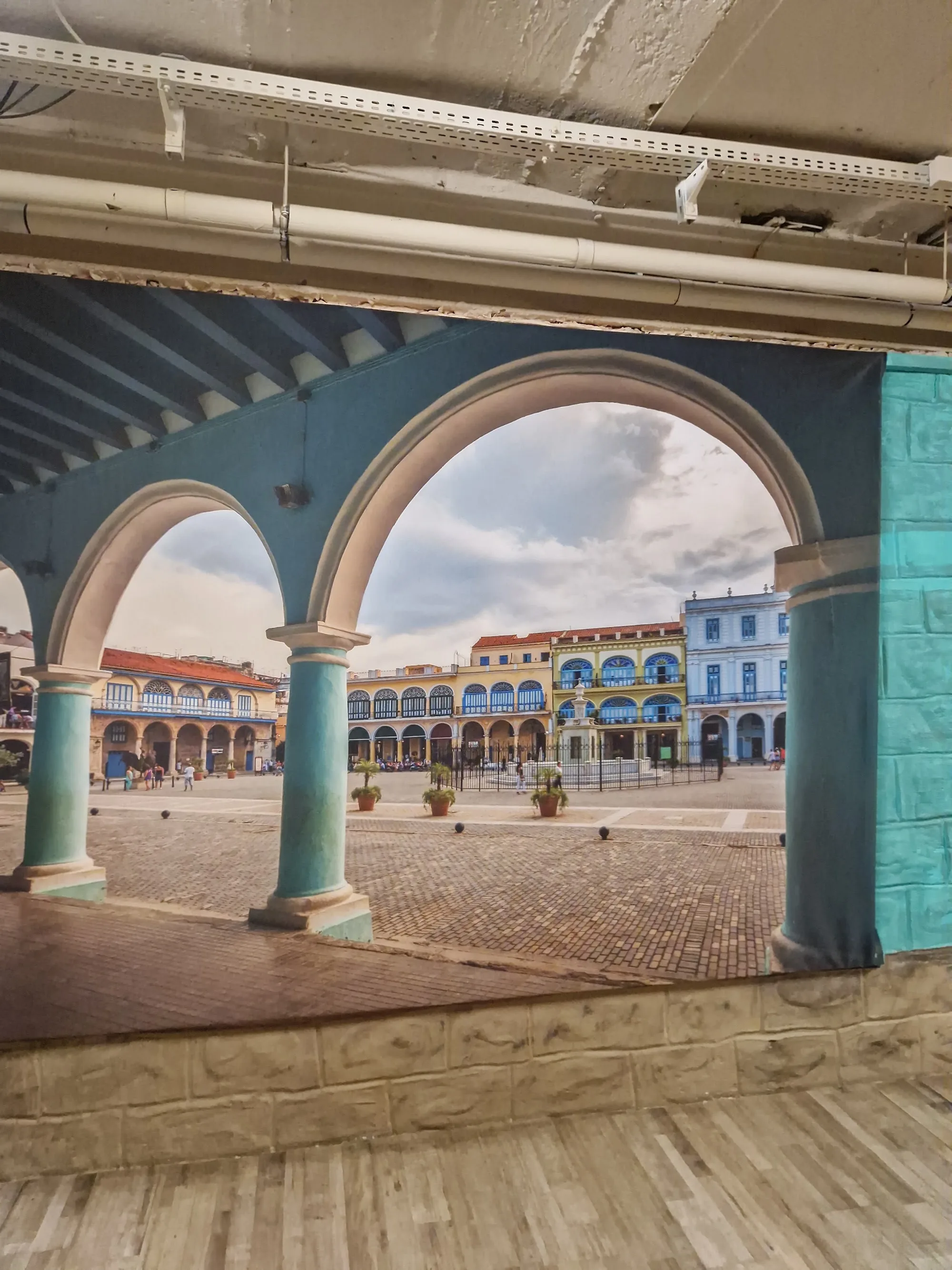 Havana plaza mural with archways framing the wooden dance floor at Havanna Star Karlsruhe