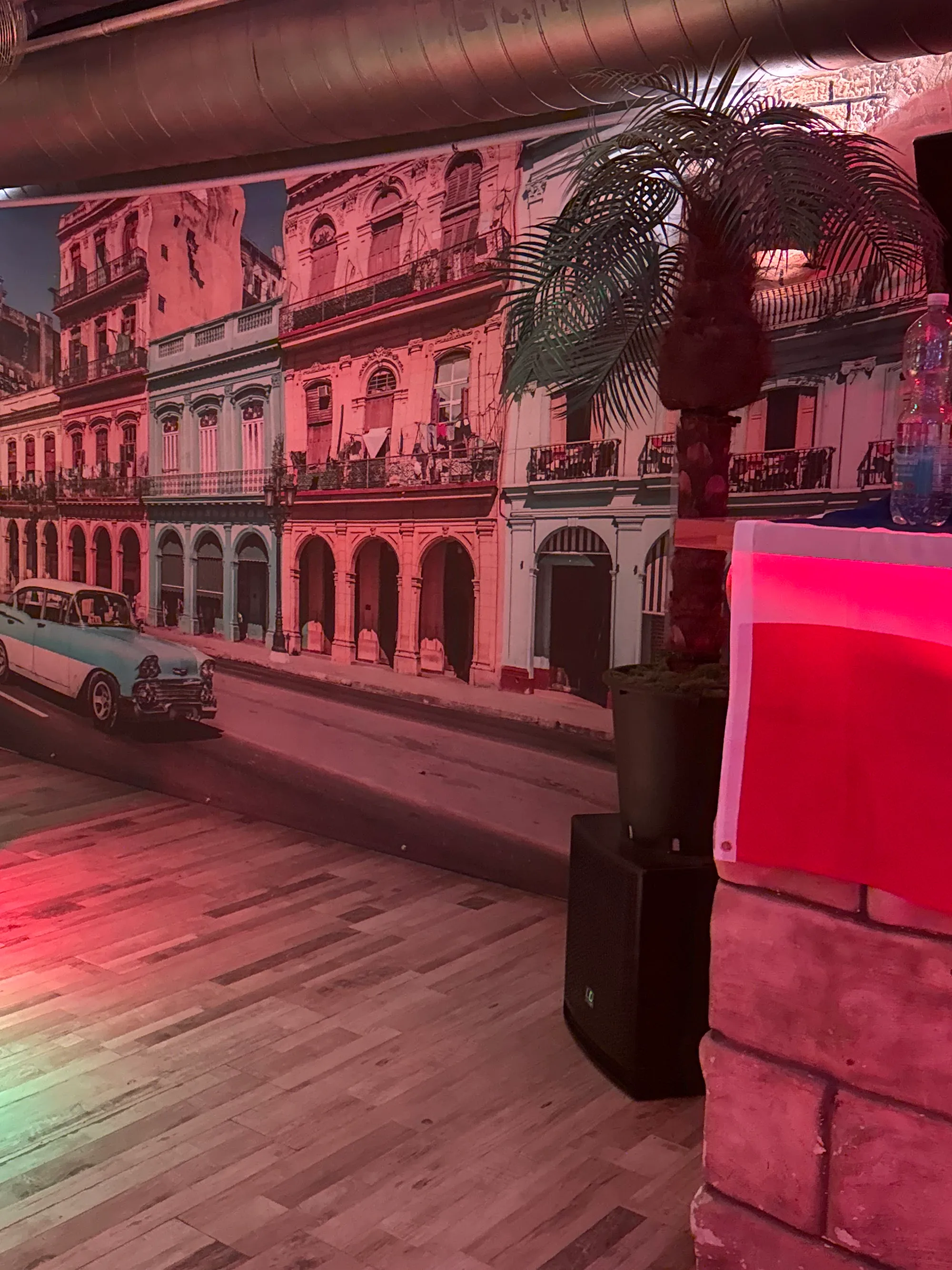 Havana street mural and wooden dance floor bathed in red light at Havanna Star Karlsruhe