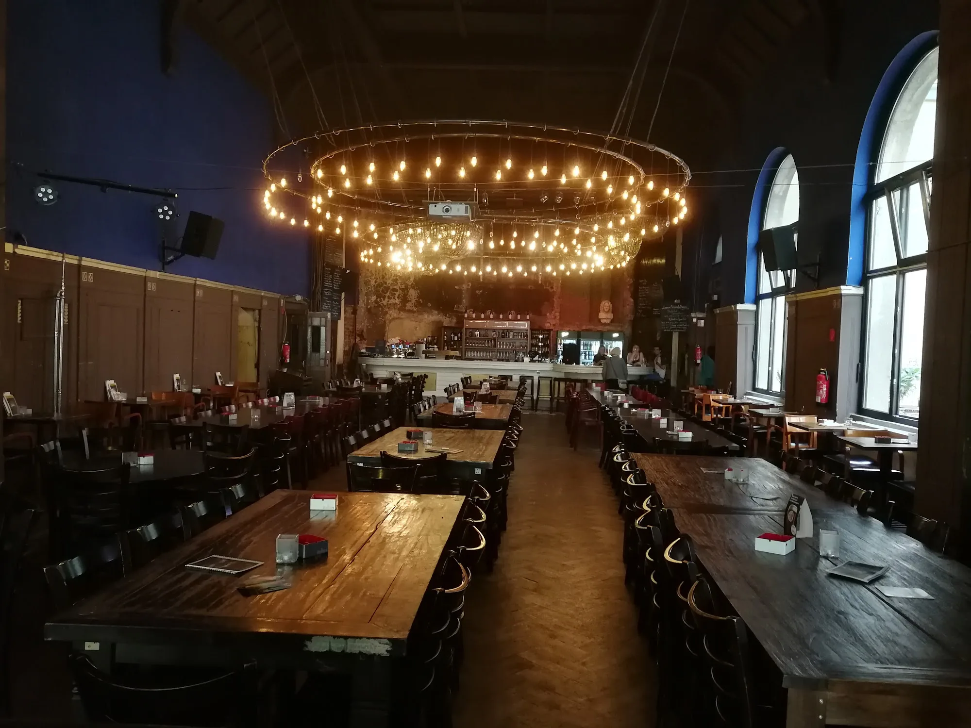 Beyerhaus grand hall interior with circular chandelier and bar at back