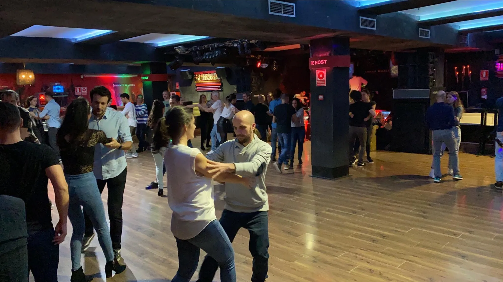 Multiple couples dancing salsa at The Host club in Madrid