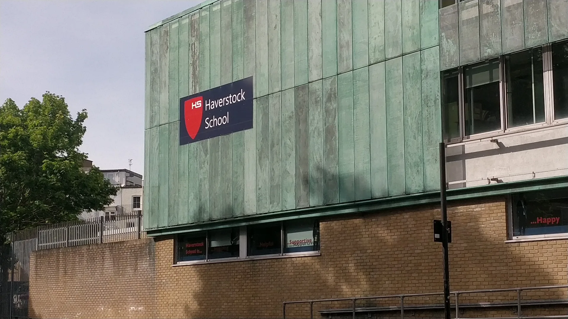 Haverstock School entrance with branded signage in London, host venue for Super Mario Salsa socials