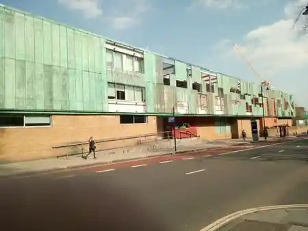 Wide exterior view of Haverstock School's green copper-clad building in Camden, London — salsa venue in London