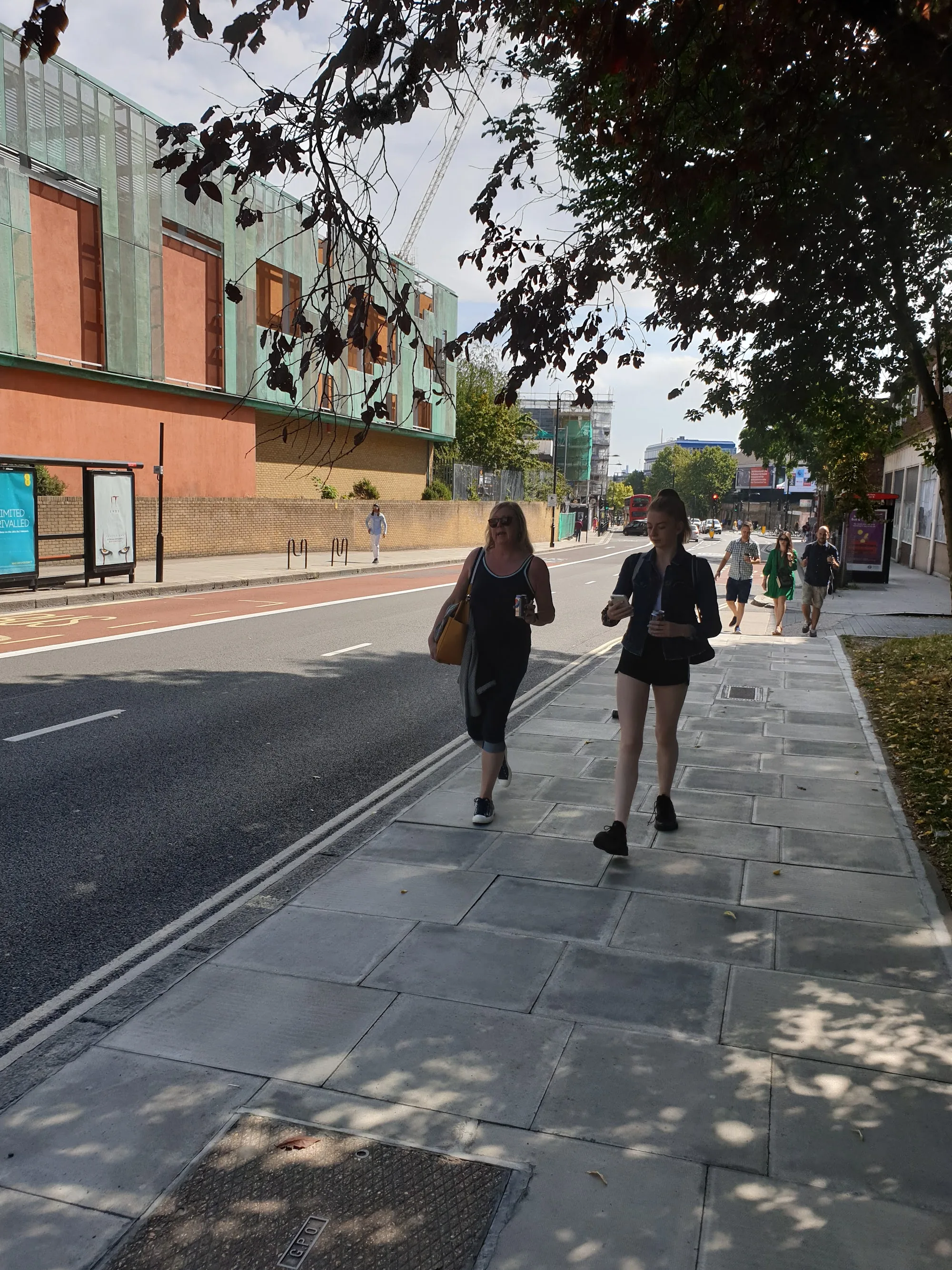 Street approach to Haverstock School in Camden, London with the venue's distinctive green facade in view