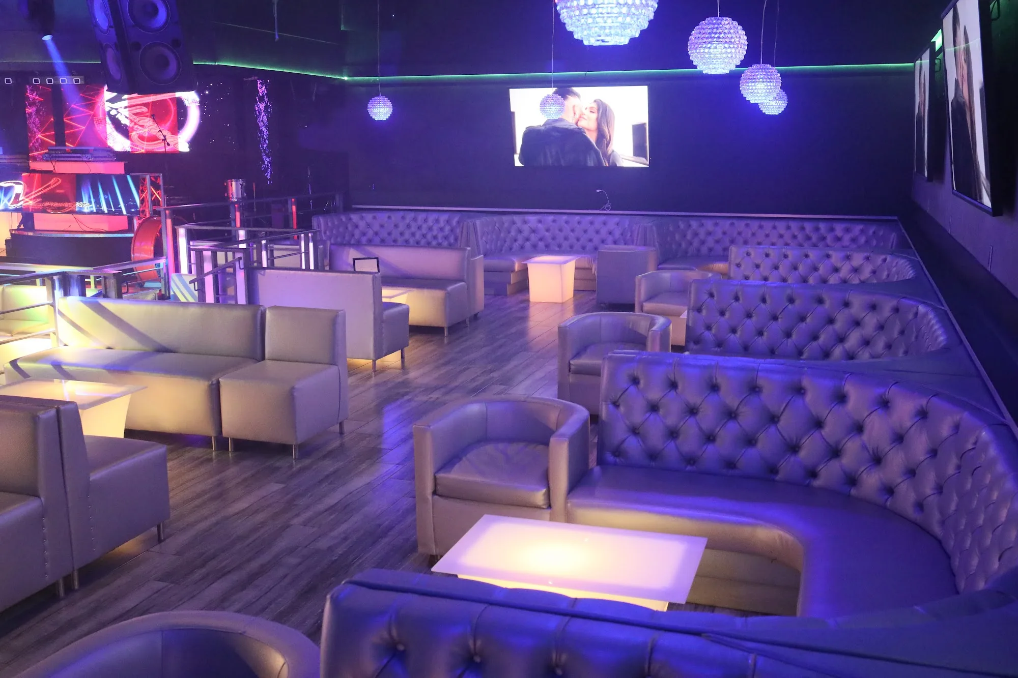 White leather lounge booths with purple LED lighting at V Lounge Bar Nightclub Los Angeles