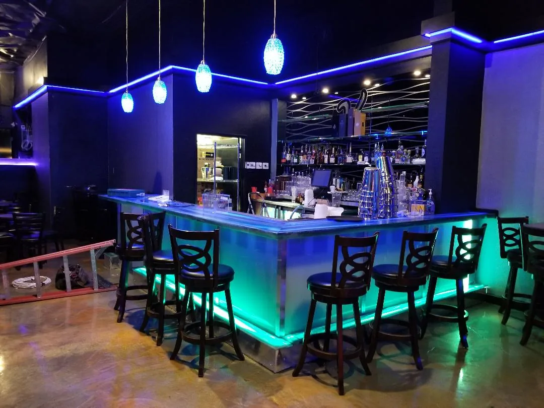 Bar area with colorful LED strip lighting at V Lounge Bar Nightclub Los Angeles