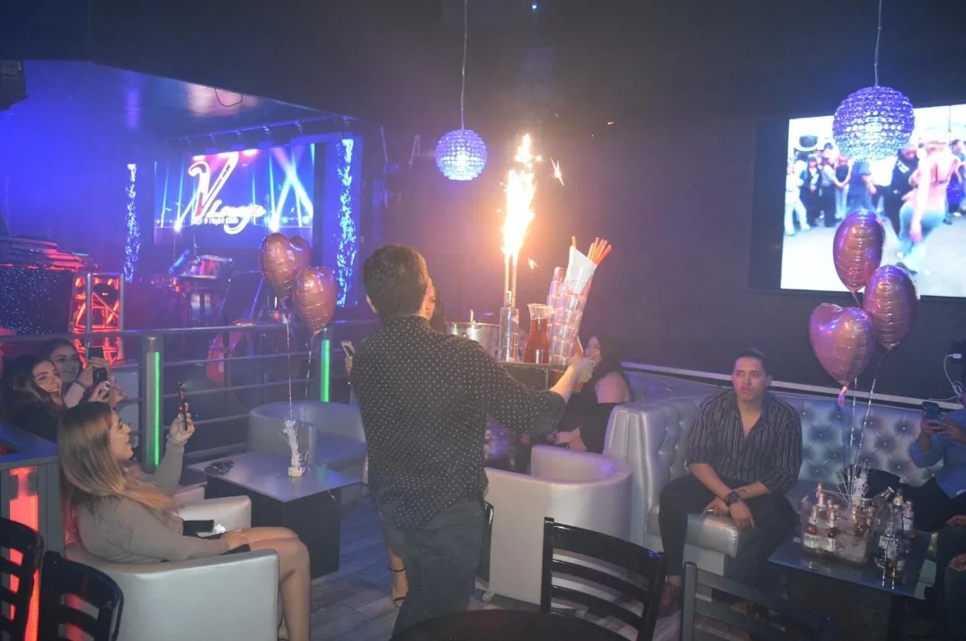 Nightclub lounge area with guests at V Lounge Bar Nightclub in Los Angeles
