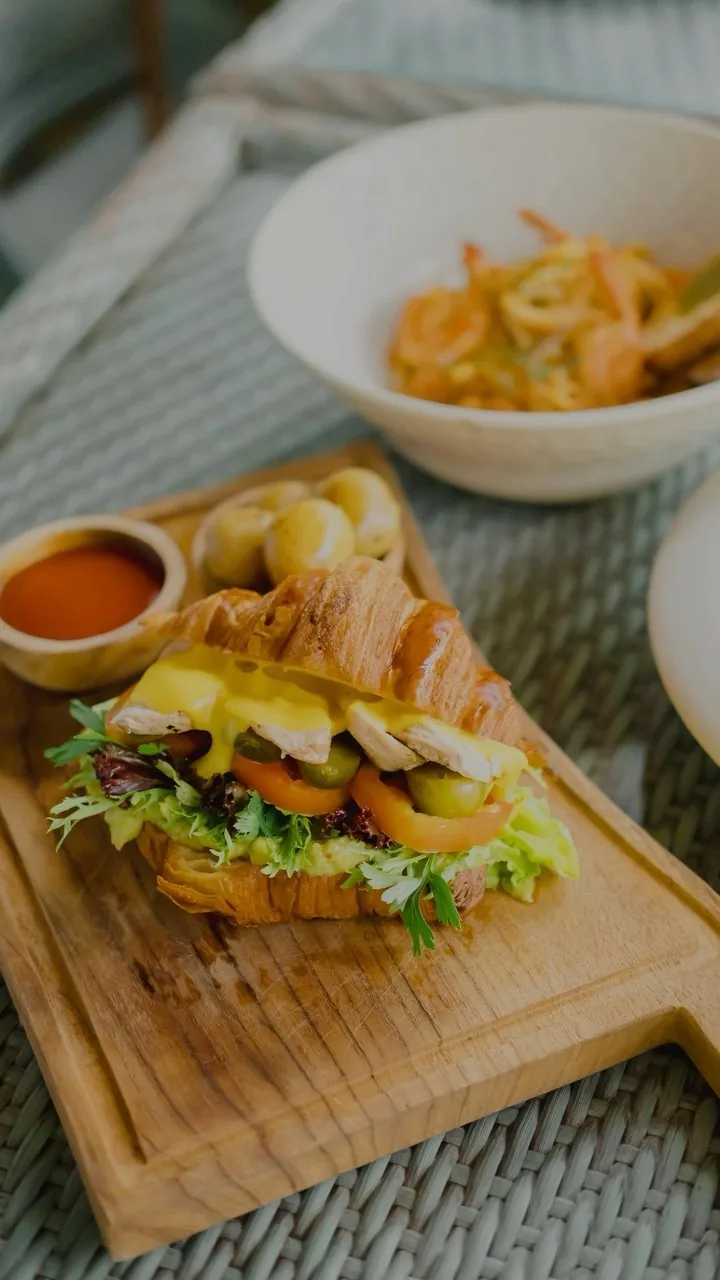 Fresh croissant sandwich and seafood bowl at Herb Library Ubud