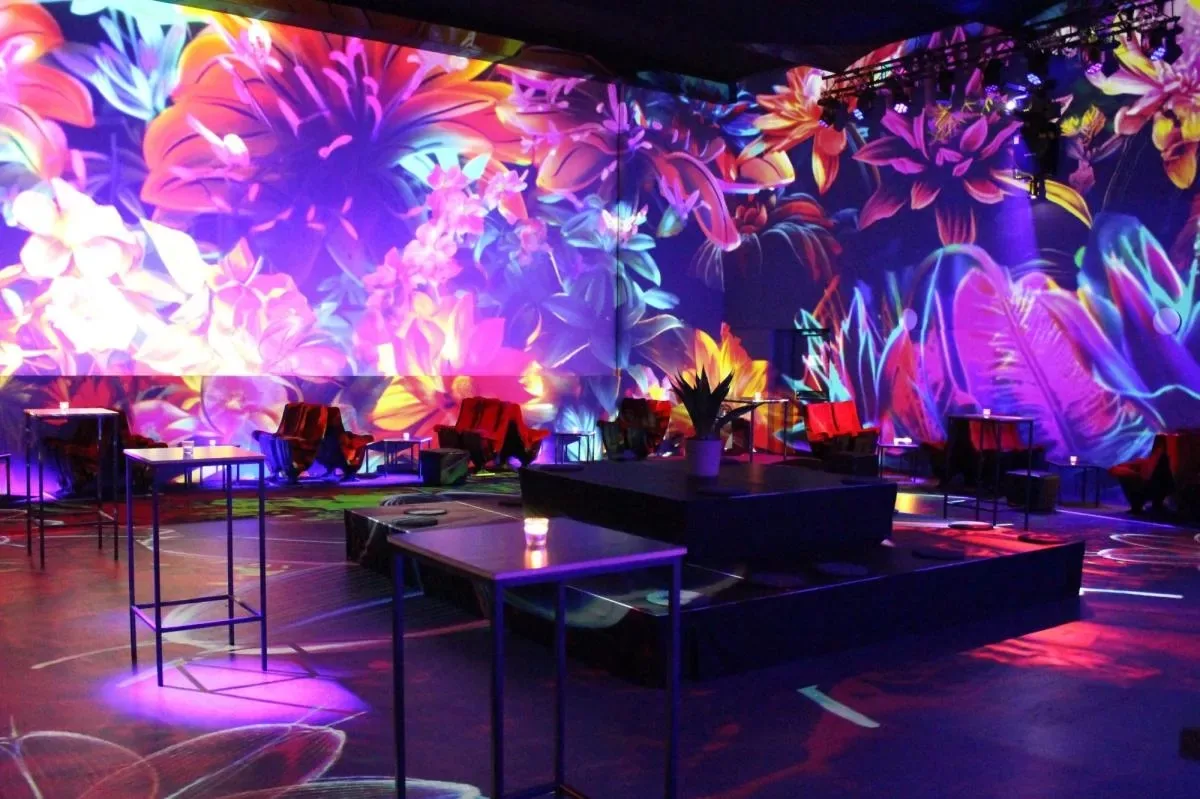 Immersive floral projections light the dance floor at Moderne Bar & Karussell in Lucerne