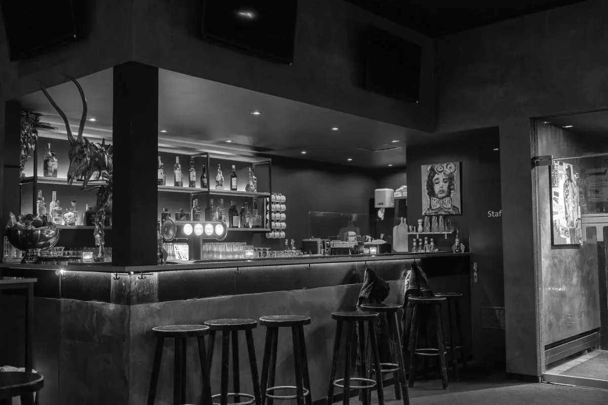 Moody black-and-white bar counter with stools at Moderne Bar & Karussell, Lucerne