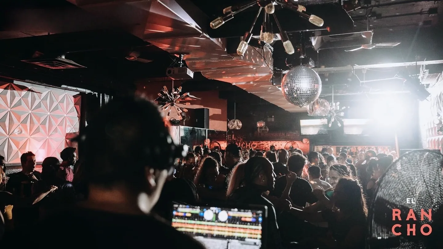 Busy Latin dance floor with crowd and disco balls under warm lighting at El Rancho in Toronto — salsa, bachata, kizomba venue in Toronto