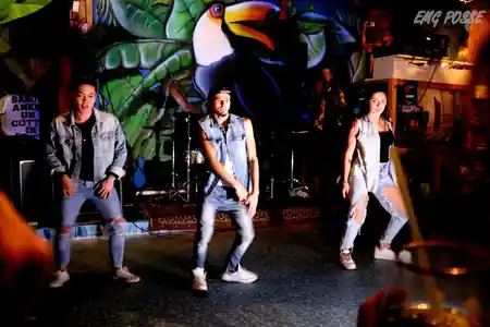 Performers dancing on stage in front of venue murals at Dandarì Disco Pub Italy — bachata, salsa venue in Villanova di Castenaso